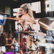 Photo of woman singing with a band on a stage